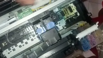 Disassembling the Canon G1010 printer’s cover to access internal components for troubleshooting Error 6000.