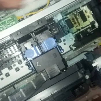 Disassembling the Canon G1010 printer’s cover to access internal components for troubleshooting Error 6000.